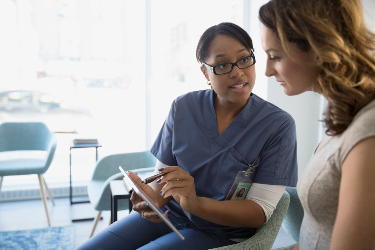 Boy holding up a large globe outdoors