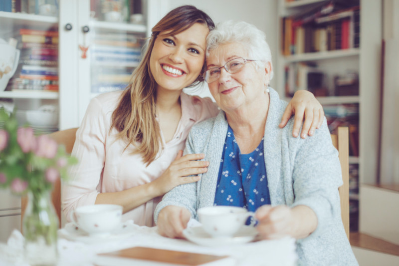 Boy holding up a large globe outdoors